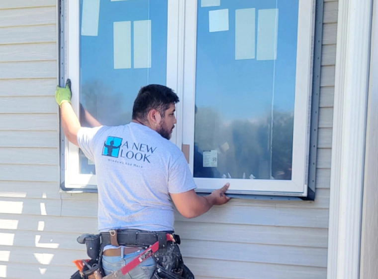 contractor installing a window for residential house